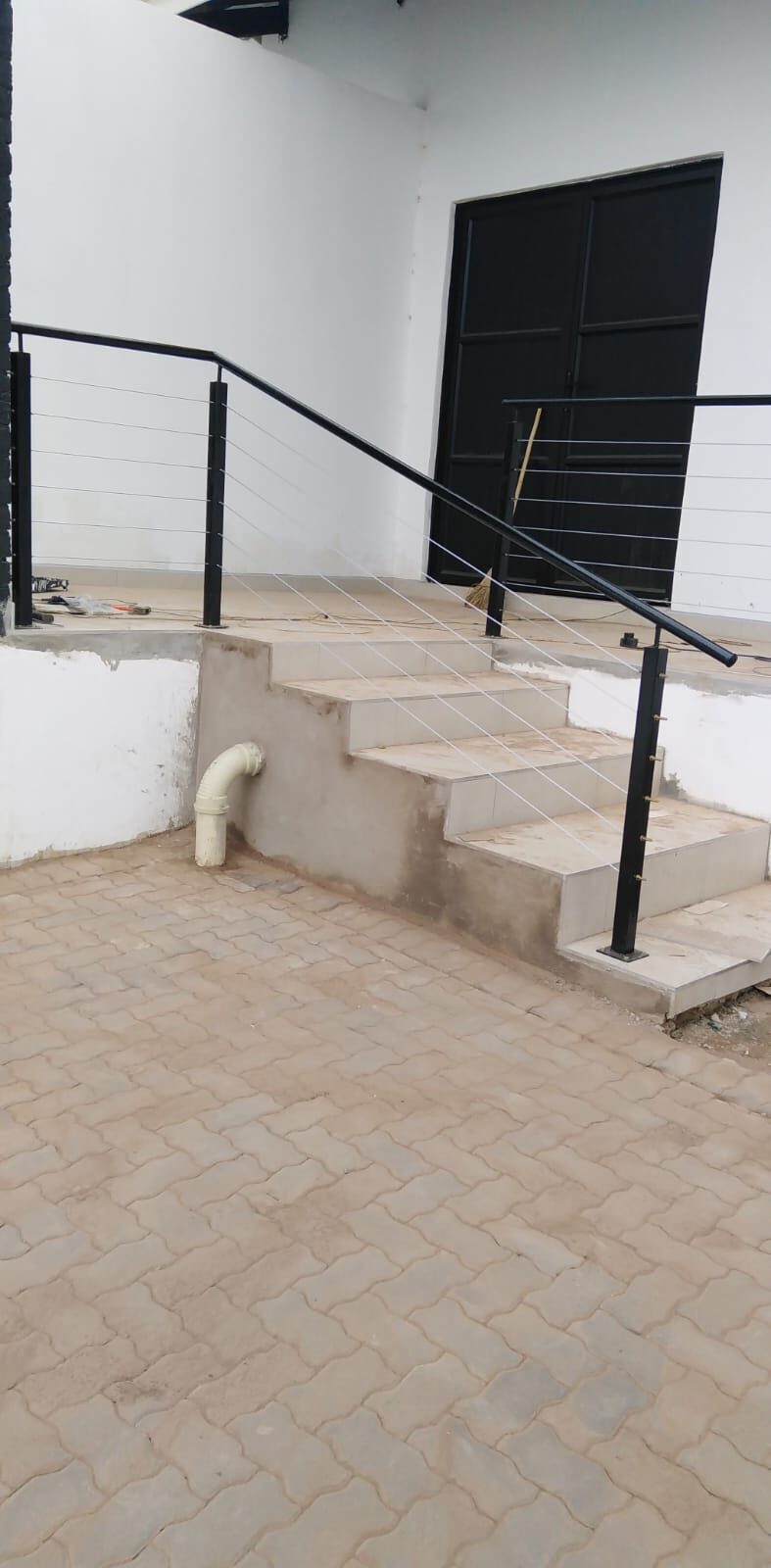 Steel balustrade with cable railing infill on an outdoor staircase