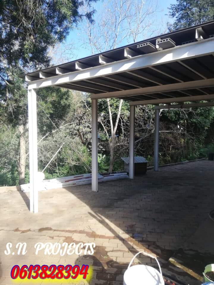 Steel carport roof installed over a paved patio