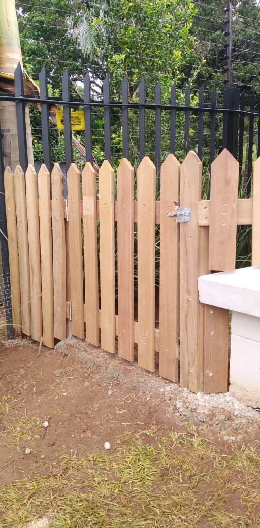 Timber picket fencing built beneath an electric security fence