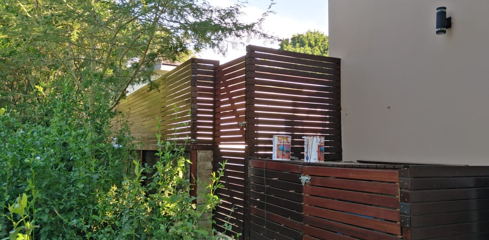 Custom timber-slat privacy screening built alongside a home