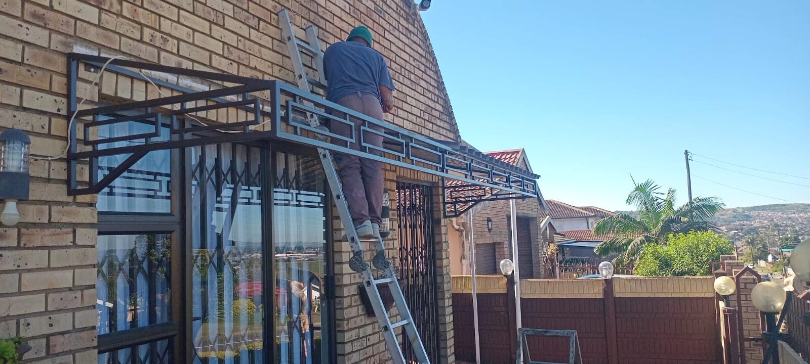 Installing a custom steel window canopy on site
